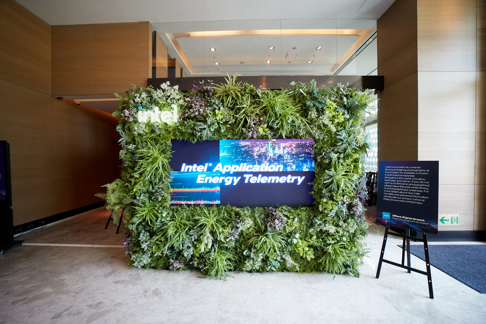A living green wall with a dimensional Intel logo and an embedded LED screen showing an application energy telemetry demo
