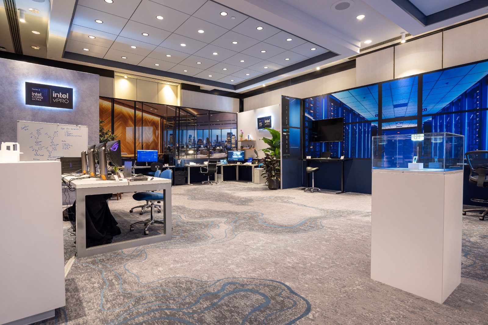 The Living Experiences floor: fully propped enterprise and IT operations environments with backlit Intel Core Ultra and vPro badges
